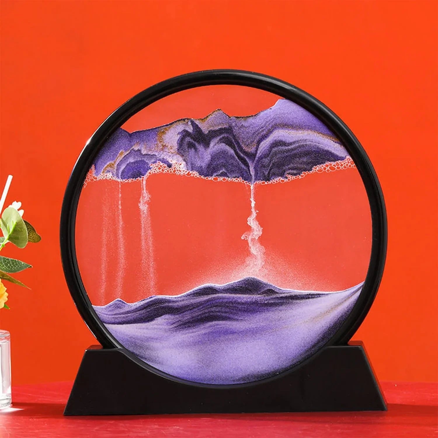 Purple sand art landscape in circular frame, home decor piece with mountain and waterfall design