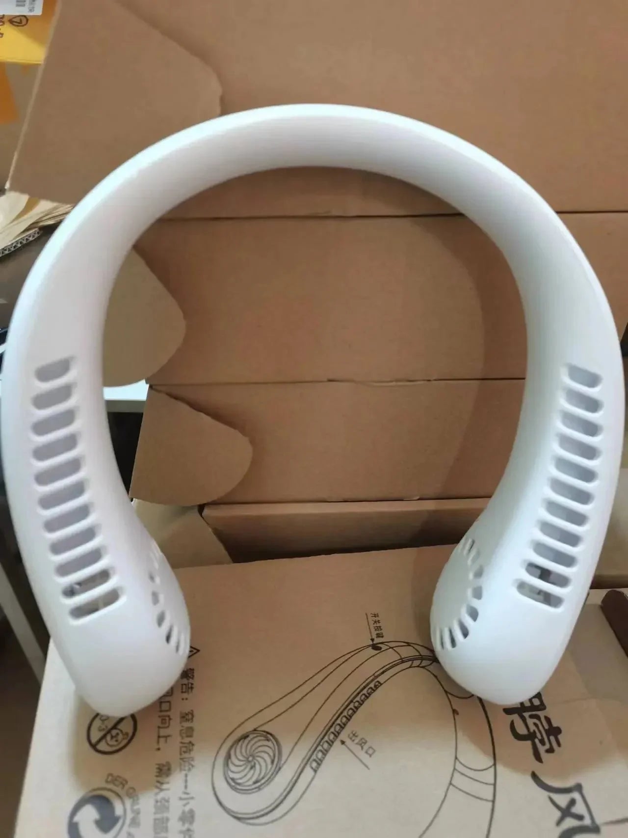 White portable neck fan for personal cooling, lightweight design with air vents, ideal for outdoor use
